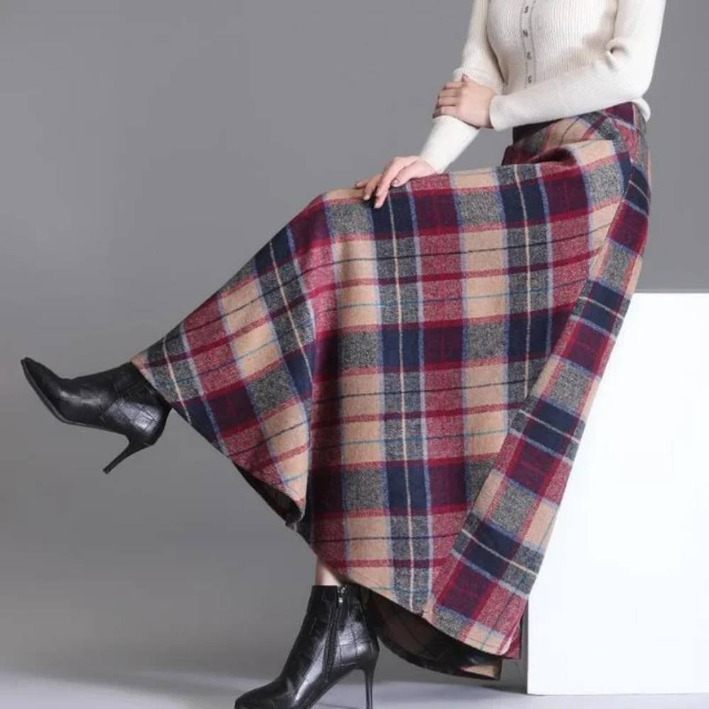 Jupe longue écossaise à carreaux rouge et bleu en tissu tartan portée avec bottines noires à talons