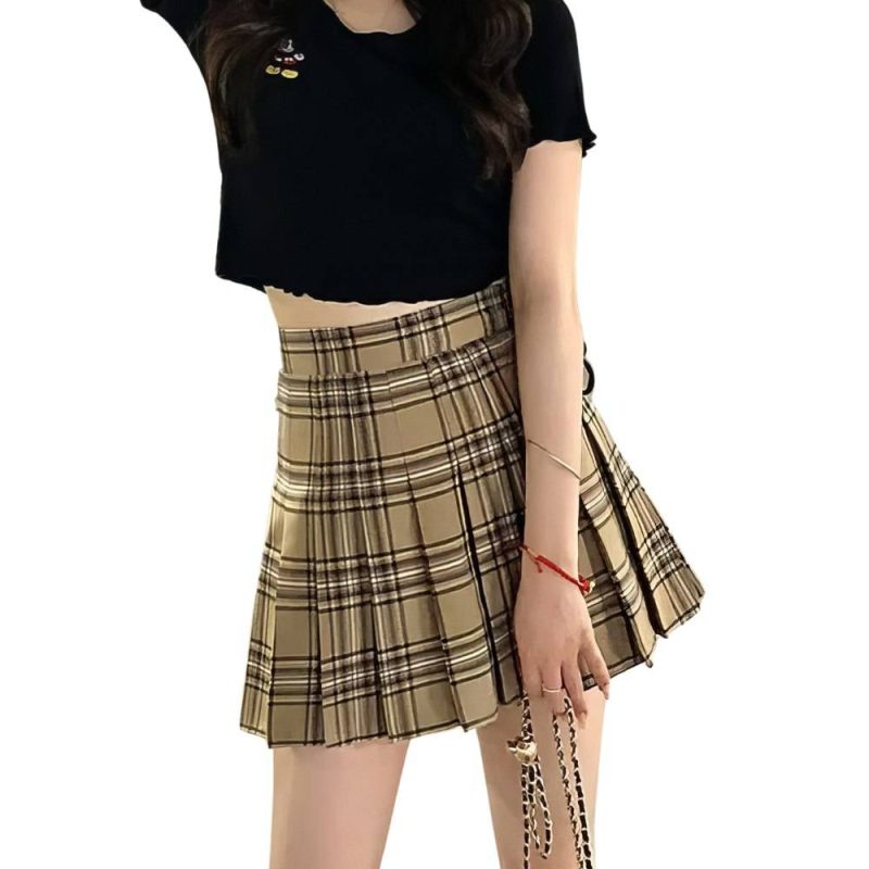 Mini jupe plissée tartan beige et noir style urbain portée par une femme